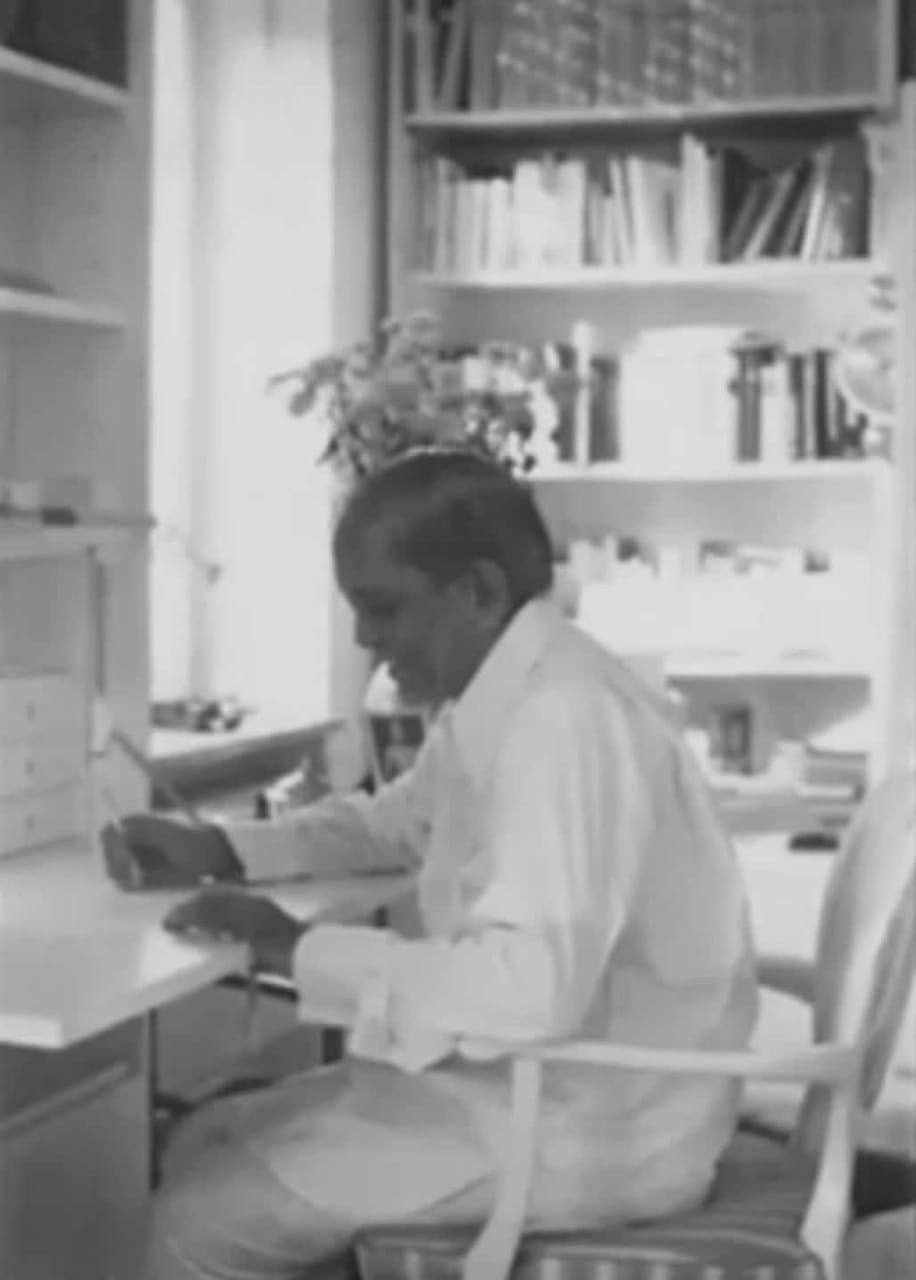 Master E.K. studying and writing